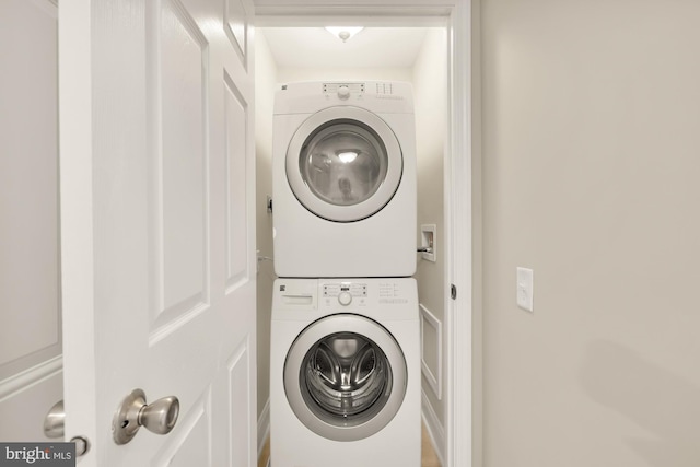 laundry room featuring laundry area and stacked washer and clothes dryer