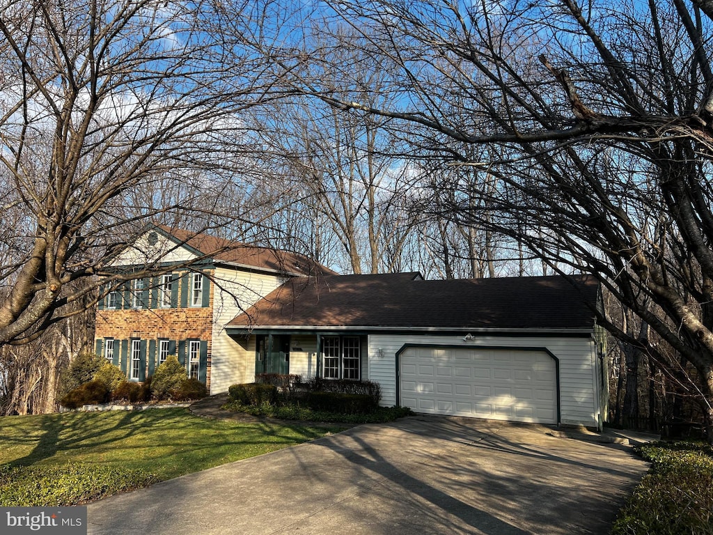 view of front of home featuring a garage and a front lawn