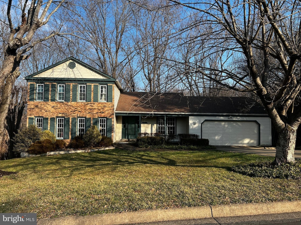 view of front of house with a garage and a front lawn