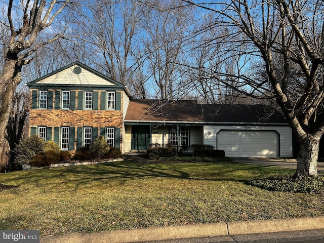 view of front of home with an attached garage, brick siding, and a front yard