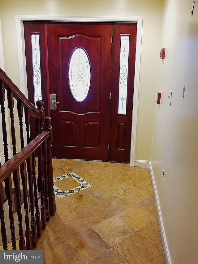 entryway with stairway and baseboards