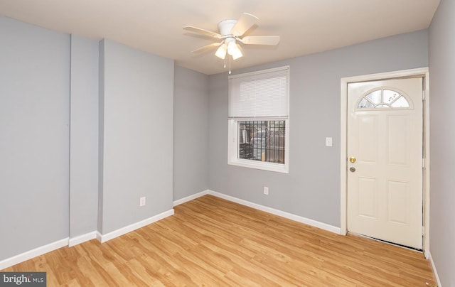 foyer with plenty of natural light, light hardwood / wood-style floors, and ceiling fan