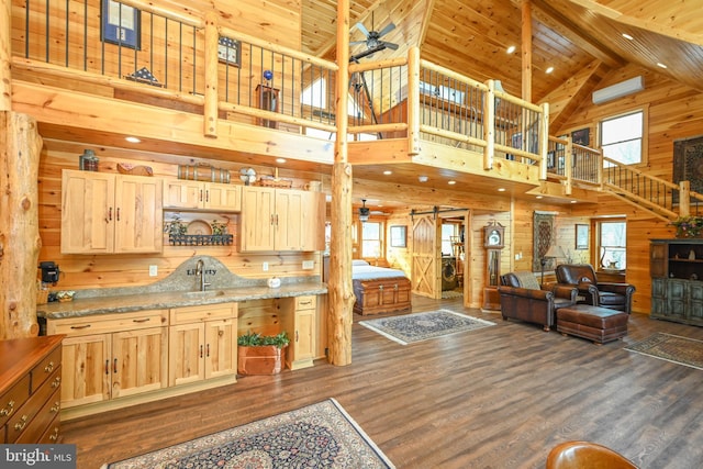 kitchen with wood ceiling, wooden walls, a wealth of natural light, and light brown cabinets