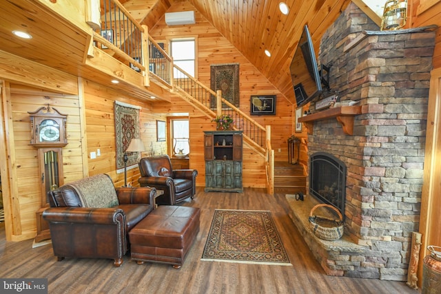 living room featuring dark hardwood / wood-style flooring, a stone fireplace, wooden ceiling, an AC wall unit, and wood walls