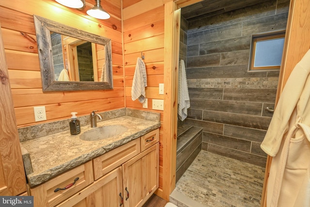 bathroom featuring vanity and wood walls