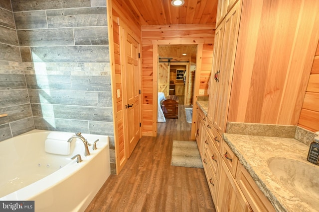 bathroom with hardwood / wood-style floors, wood walls, a tub to relax in, vanity, and wooden ceiling