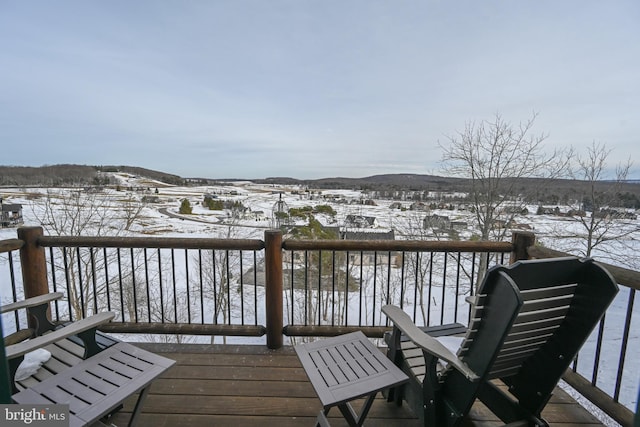 snow covered deck with a mountain view