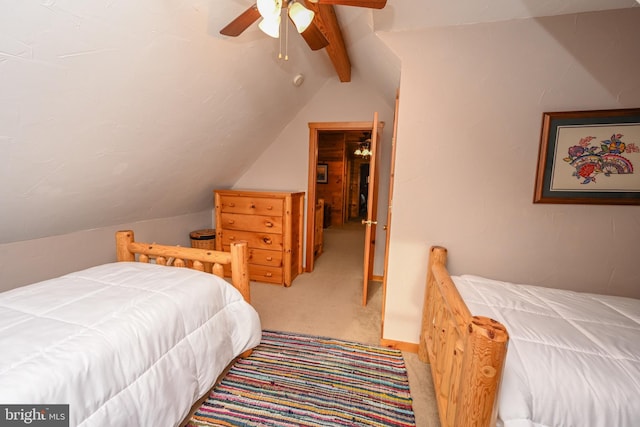 carpeted bedroom featuring lofted ceiling with beams and ceiling fan