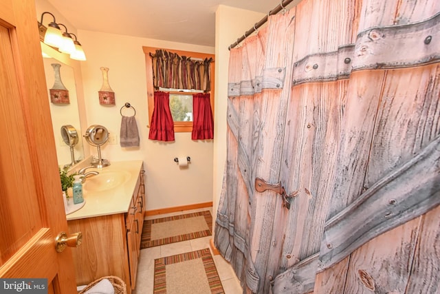 bathroom with tile patterned floors and vanity