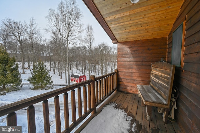 view of snow covered back of property