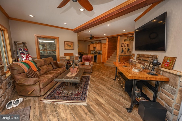 living room featuring hardwood / wood-style flooring, ceiling fan, ornamental molding, and beamed ceiling