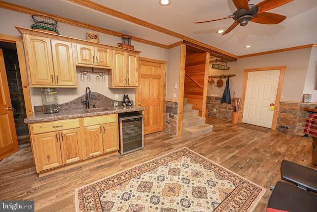 kitchen with wine cooler, sink, hardwood / wood-style flooring, and dark stone counters