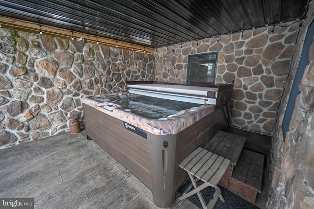 wooden deck featuring a hot tub