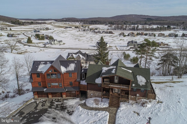 snowy aerial view with a mountain view