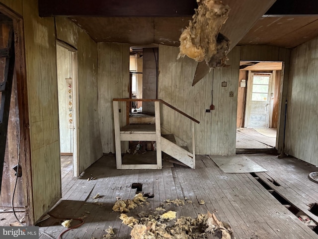 misc room with hardwood / wood-style flooring and wooden walls