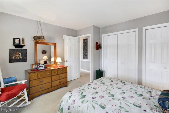 carpeted bedroom featuring multiple closets