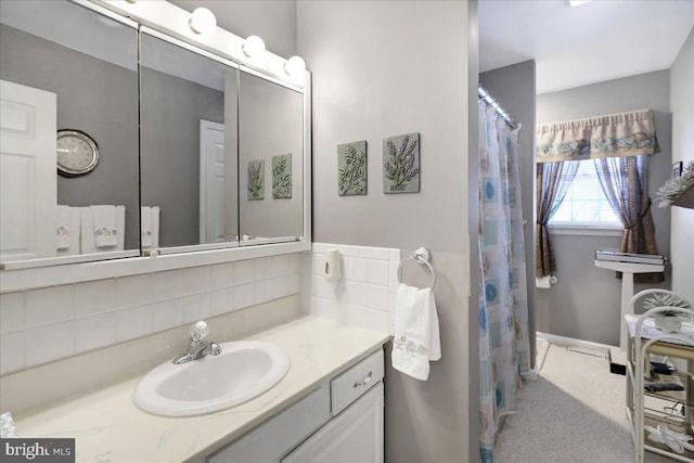 bathroom with tasteful backsplash and vanity