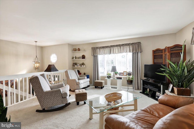 living room featuring carpet floors, a notable chandelier, and plenty of natural light