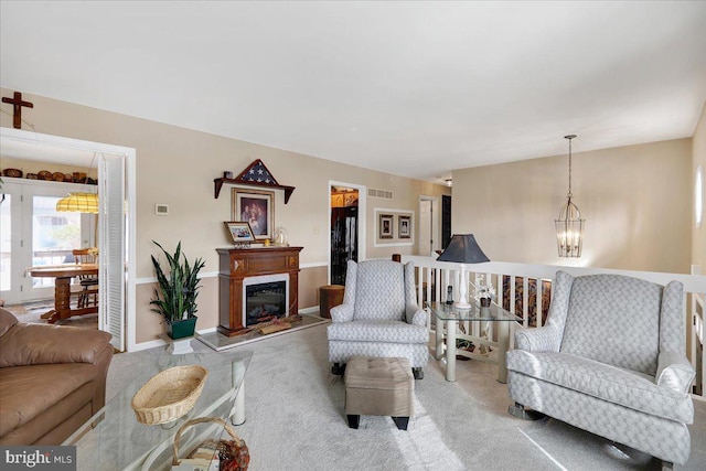 living room with a chandelier and light carpet