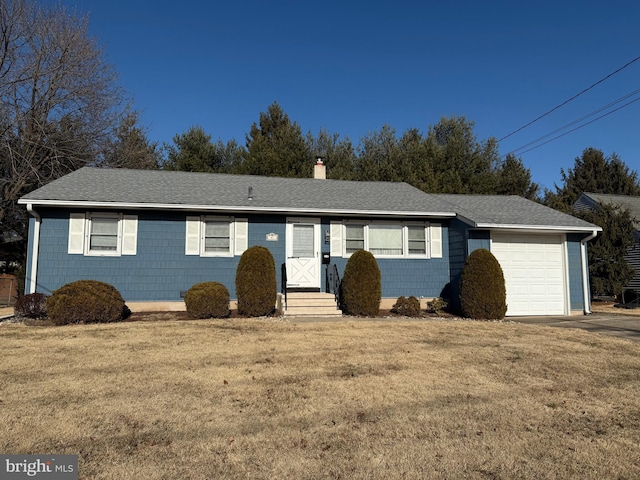 single story home featuring a garage and a front yard