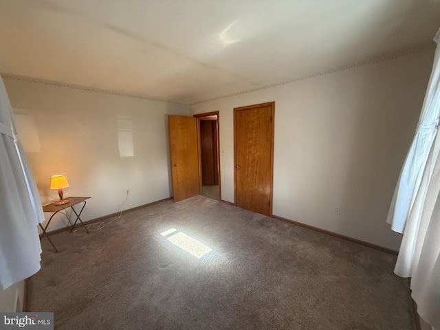 unfurnished bedroom with dark carpet