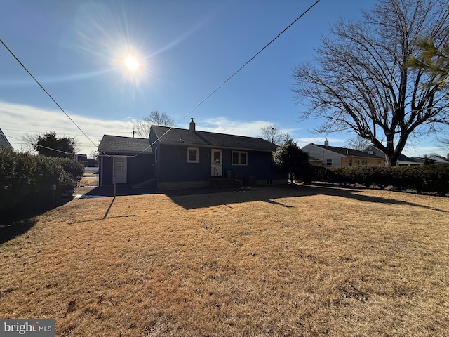 rear view of property with a yard