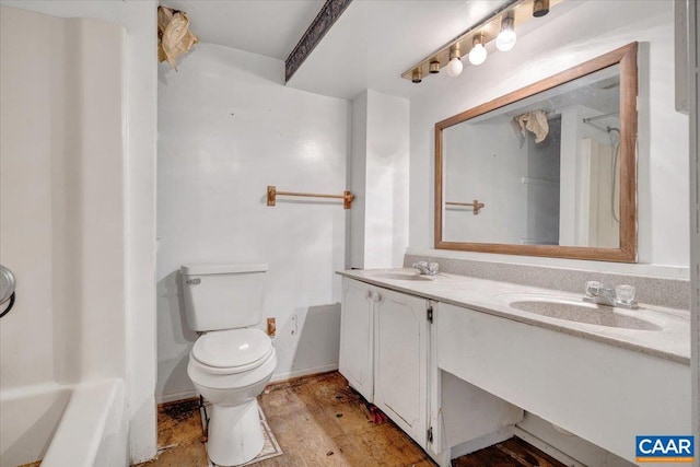 bathroom with hardwood / wood-style flooring, vanity, and toilet