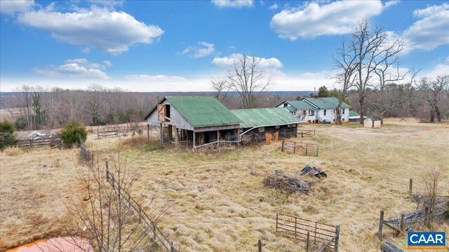 rear view of house featuring an outbuilding and a rural view