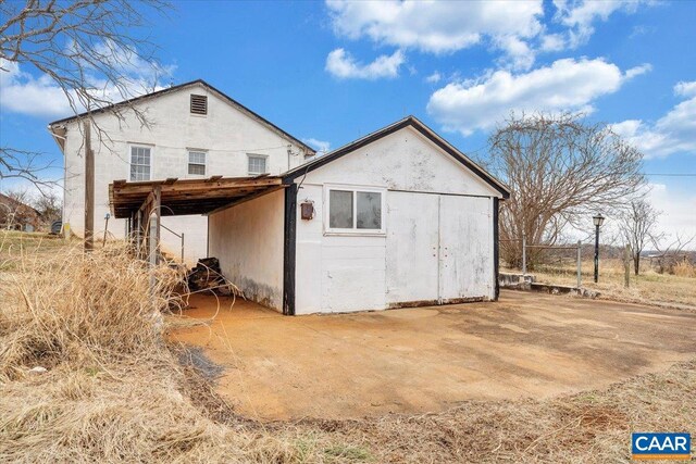 back of property featuring an outdoor structure