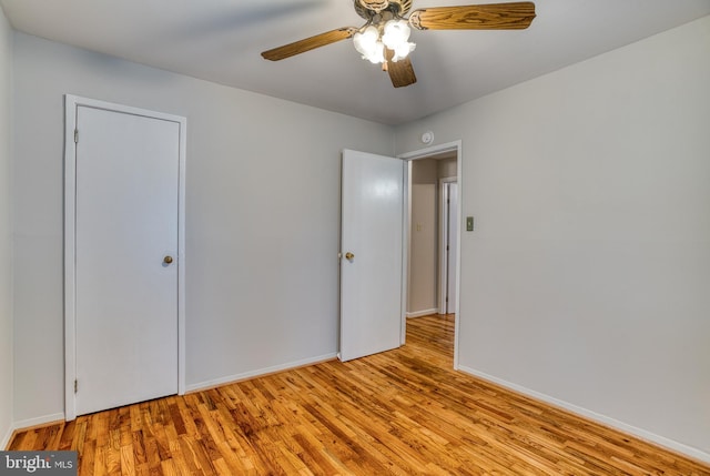 unfurnished bedroom with wood finished floors, ceiling fan, and baseboards