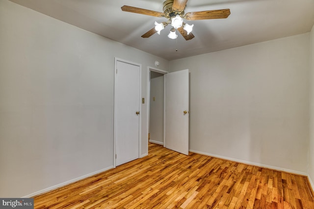 spare room with light wood-style flooring, baseboards, and ceiling fan