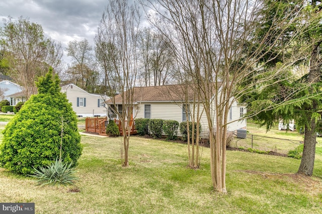 view of yard with fence and a wooden deck