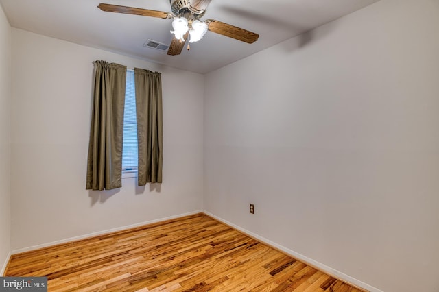 empty room with light wood finished floors, visible vents, baseboards, and a ceiling fan