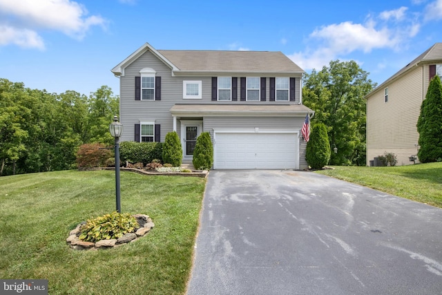 view of front of home featuring a garage and a front yard