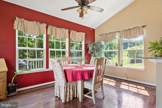 dining space with ceiling fan, vaulted ceiling, and wood-type flooring