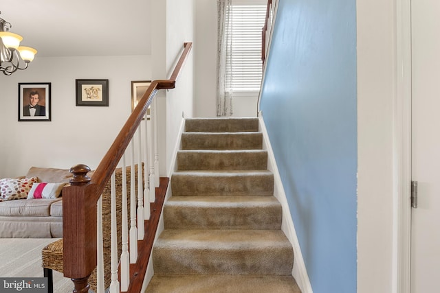 stairs featuring an inviting chandelier