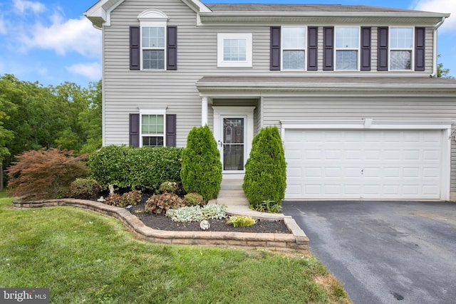 view of front of house with a garage and a front yard