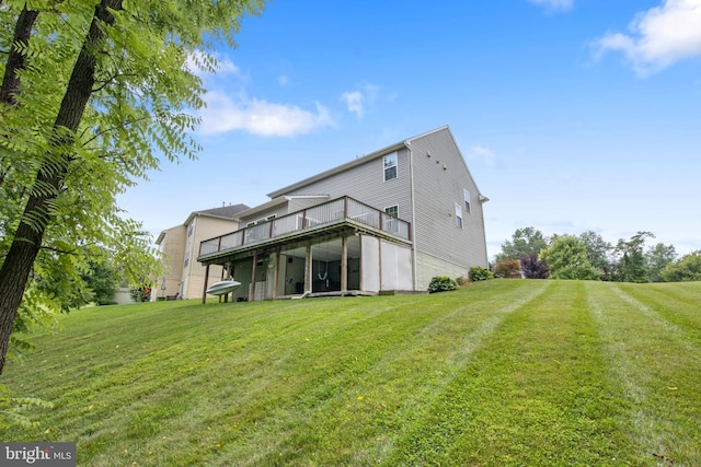 back of house featuring a wooden deck and a yard