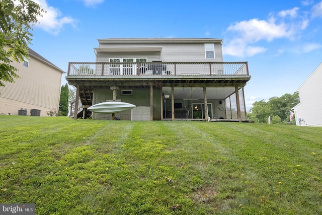 rear view of house featuring a wooden deck, a yard, and central AC