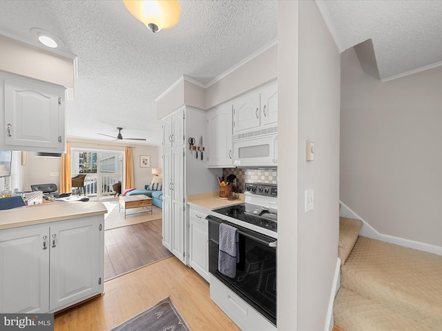 kitchen with electric range oven, white cabinetry, backsplash, crown molding, and light hardwood / wood-style flooring