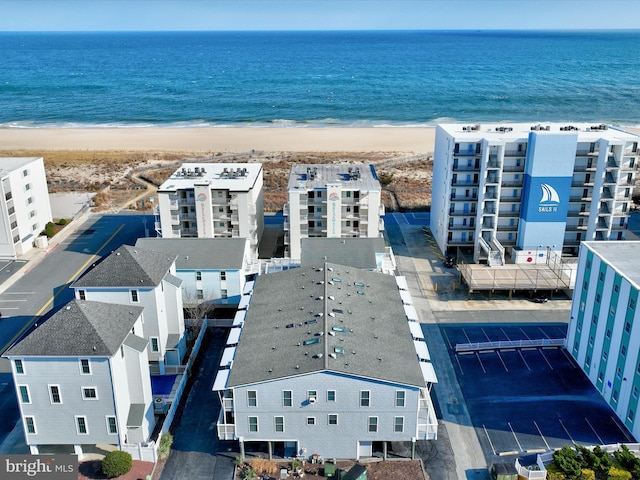 birds eye view of property featuring a water view and a view of the beach