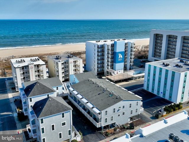 bird's eye view with a water view and a beach view