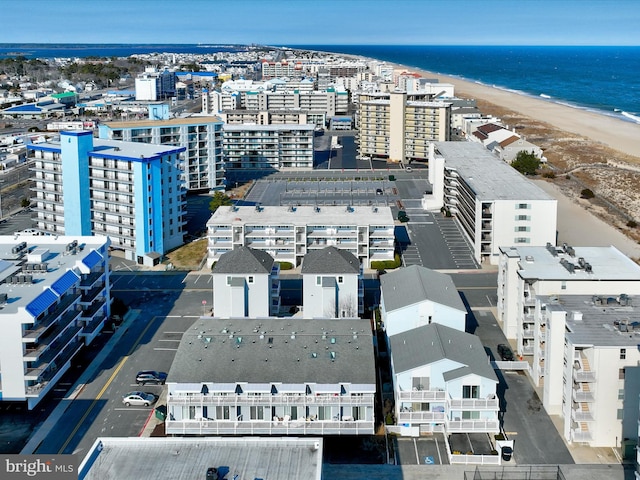 birds eye view of property with a view of the beach and a water view