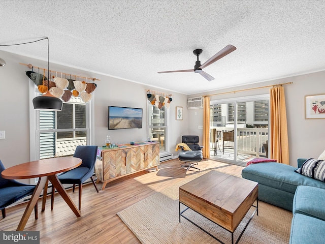 living room featuring a wall mounted air conditioner, a baseboard radiator, ceiling fan, a textured ceiling, and light hardwood / wood-style flooring