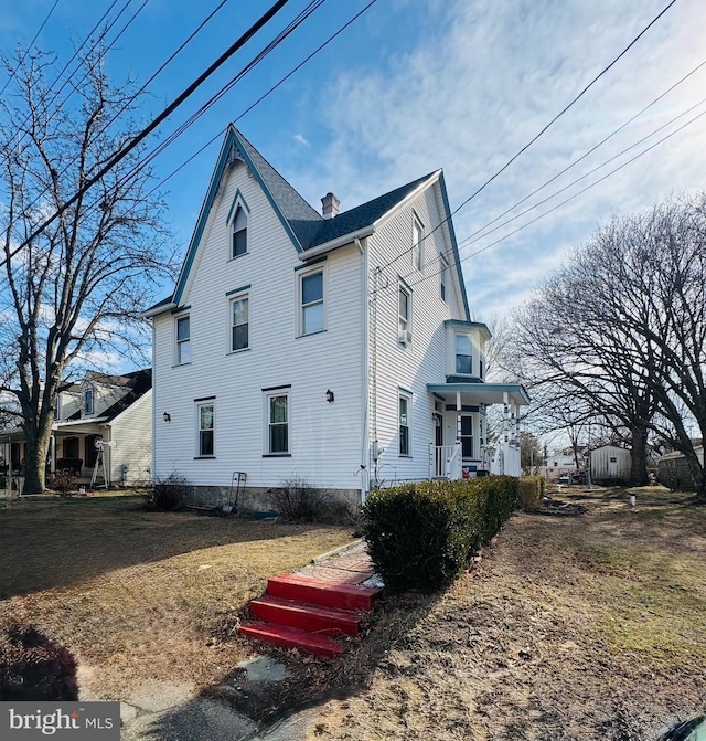 view of side of property with a lawn