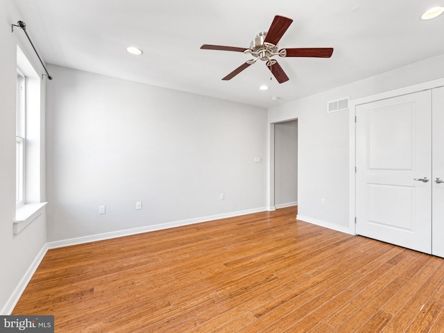 unfurnished bedroom with ceiling fan, a closet, and light hardwood / wood-style flooring