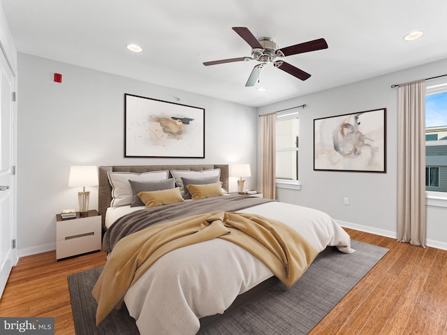 bedroom with ceiling fan and light wood-type flooring