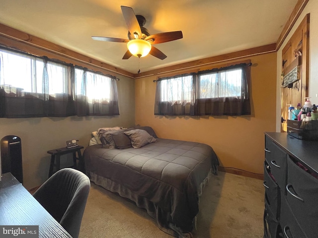 bedroom with light carpet and ceiling fan