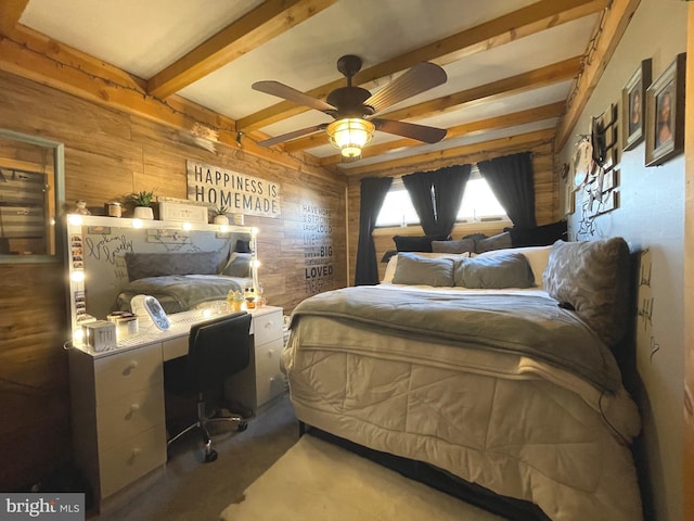 bedroom with ceiling fan, beamed ceiling, and wood walls