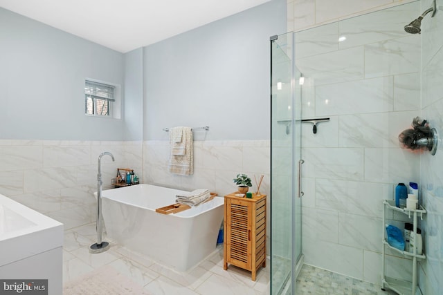 bathroom featuring plus walk in shower and tile walls